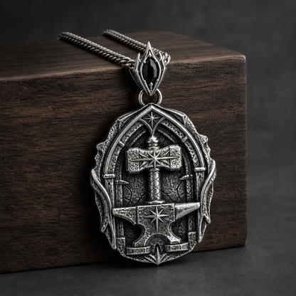 Oxidized 925 sterling silver pendant necklace with a raised hammer, anvil form, star details, arched forge-style frame, and included curb chain.