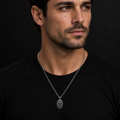 Oxidized 925 sterling silver pendant necklace with curb chain, raised oval memory-core center, root-like relief details, flowing mist shapes, and antique dark finish.