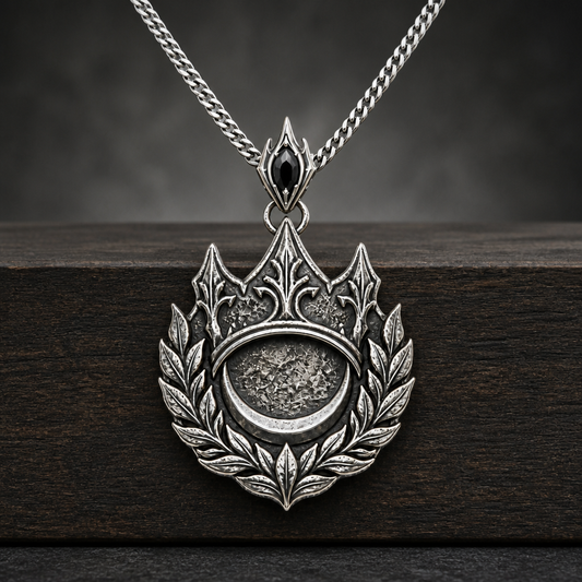 Oxidized 925 sterling silver pendant necklace with a crown, laurel wreath, crescent medallion, black faceted accent on the bail, and curb chain.