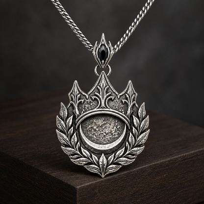 Oxidized 925 sterling silver pendant necklace with a crown, laurel wreath, crescent medallion, black faceted accent on the bail, and curb chain.
