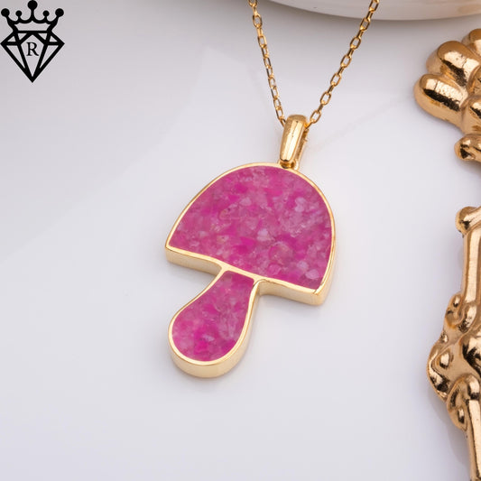 Raised cap and stem detail of the mushroom-shaped pink agate pendant