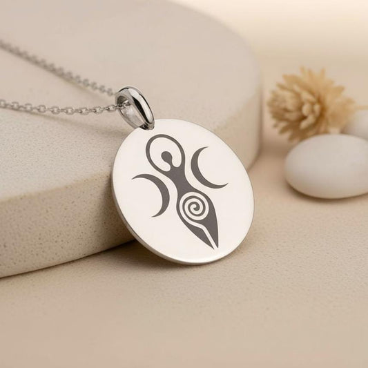 Silver round goddess medallion pendant on a neutral stone surface
