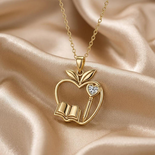 Gold Plated Silver Teacher Apple Necklace with open book, pencil, and clear accent on champagne satin