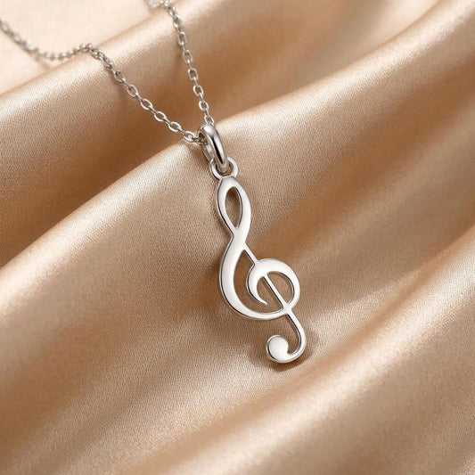 Close-up of an openwork treble clef pendant on champagne satin