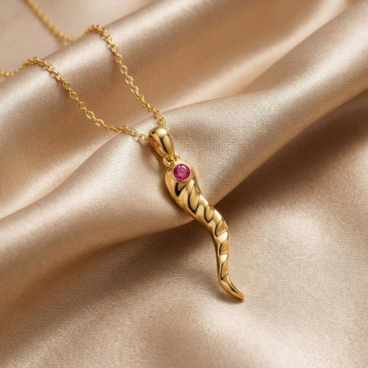 Gold Plated Silver curved twisted horn pendant with a pink stone accent on champagne satin