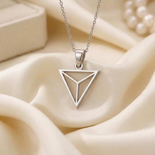 Silver Triangle Necklace with an inverted three-section pendant on cream satin