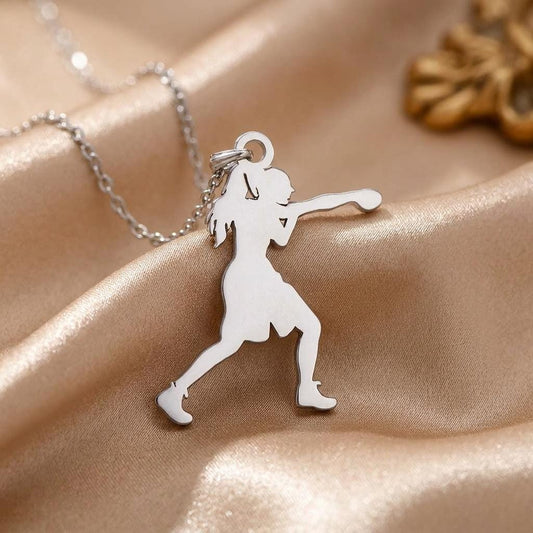 Close-up of the polished Boxing Woman pendant with a forward punch, ponytail, and deep lunge pose on champagne satin