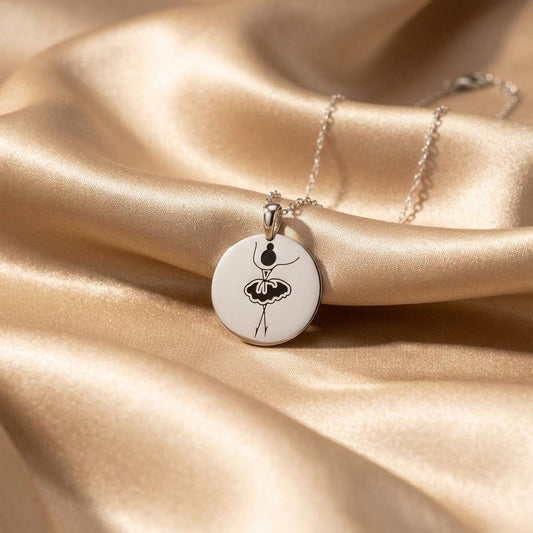 Silver engraved round ballerina pendant necklace arranged on champagne satin