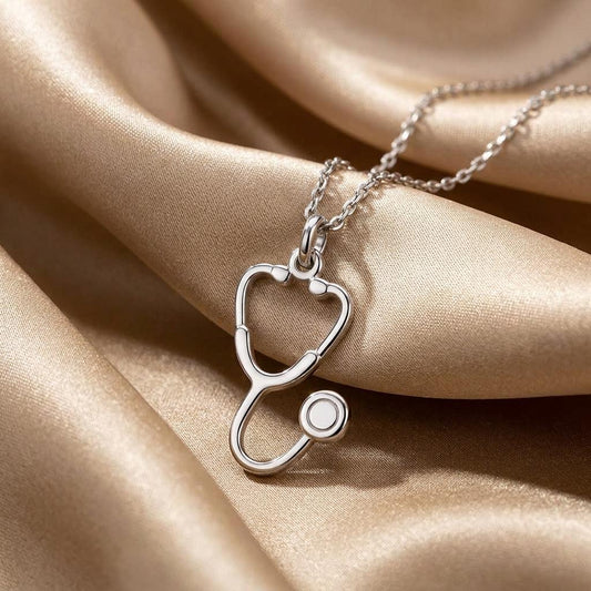 Close-up of the 925 sterling silver Doctor Stethoscope Necklace on champagne satin