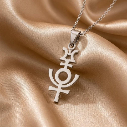 Close-up of the silver Serapis symbol pendant on champagne satin