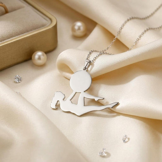 Close-up of a reclining yoga pose pendant with a bent knee on cream satin
