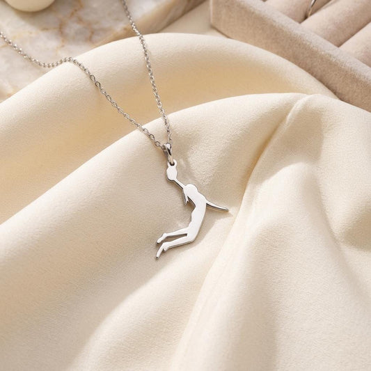 Female Basketball Player Necklace displayed on ivory fabric