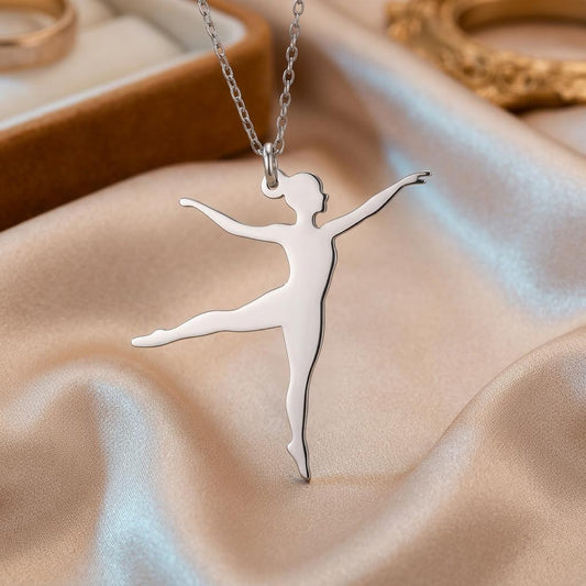 Close-up of polished 925 sterling silver Ballet Dancer side-leap pendant on champagne satin