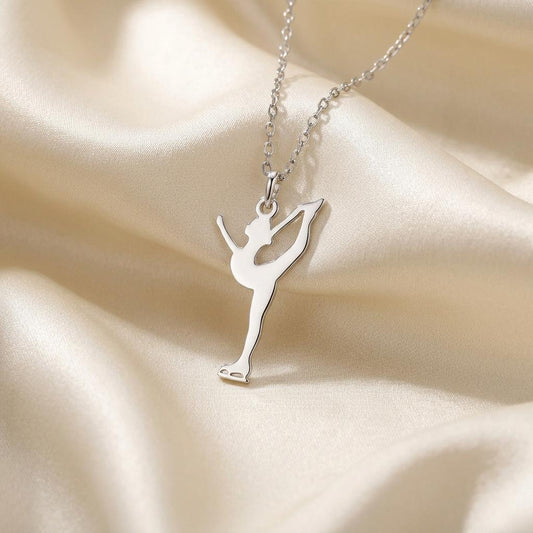 Close-up of a silver catch-foot Figure Skater Necklace with a visible supporting skate blade on ivory satin