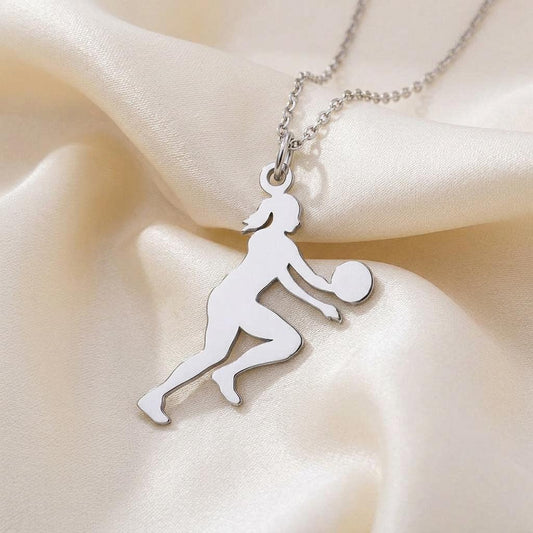 Close-up of a silver athlete-and-ball pendant on ivory satin