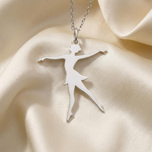 Close view of the Ballet Dancer Necklace pendant with a flared skirt on ivory satin