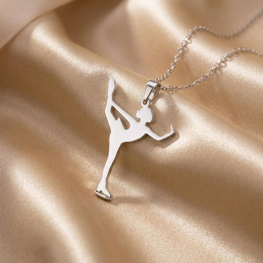 Close-up of the Figure Skater pendant on champagne satin showing the raised leg and ice skate blade