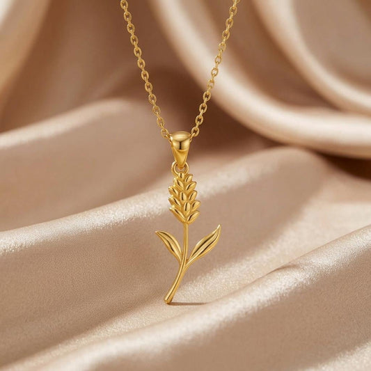 Gold Plated Silver Statice Flower Pendant Necklace with a textured floral sprig on champagne satin