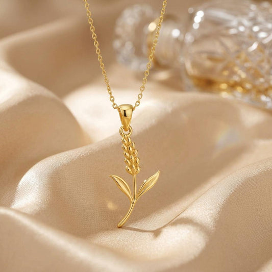 Gold Plated Silver botanical pendant necklace displayed on champagne satin